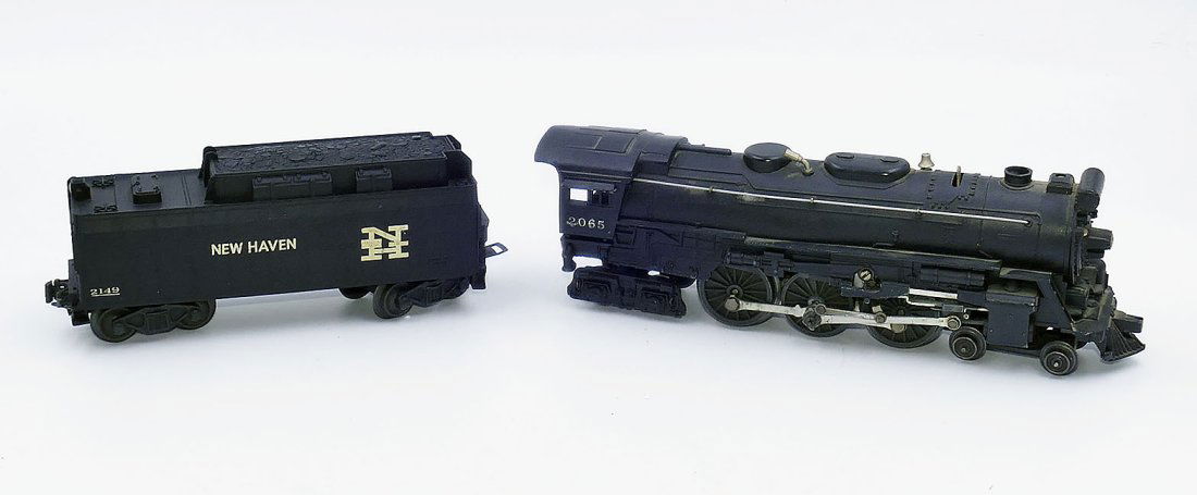 Lionel 2065 Postwar 0-4-0 Locomotive & 6026W Tender: Lionel 2065 Postwar 0-4-0 Locomotive & 6026W Tender. In good condition with some wear consistent with age and use.