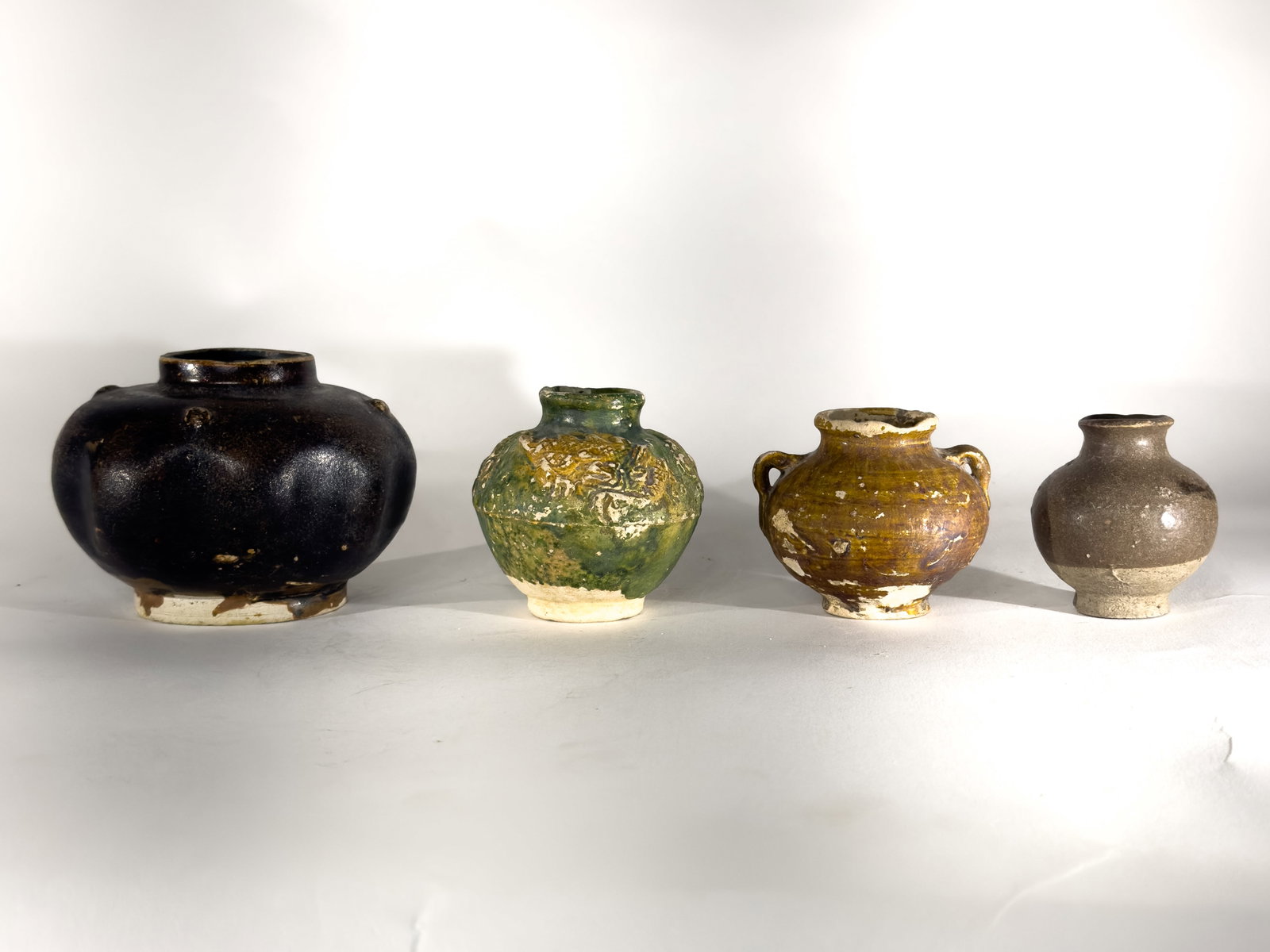 A Group of Four Glazed Asian Pottery Jars (1 of 3)