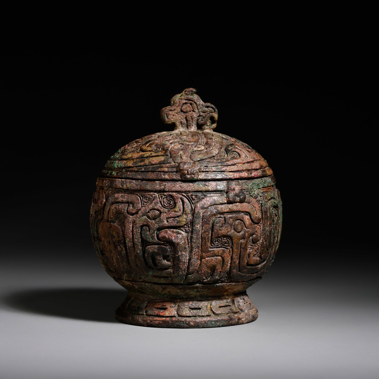 Pre-Ming Dynasty Bronze Phoenix-Finial Coiled Chilong Covered Box: H. 11.5cm.W.9cm.weight.641grams