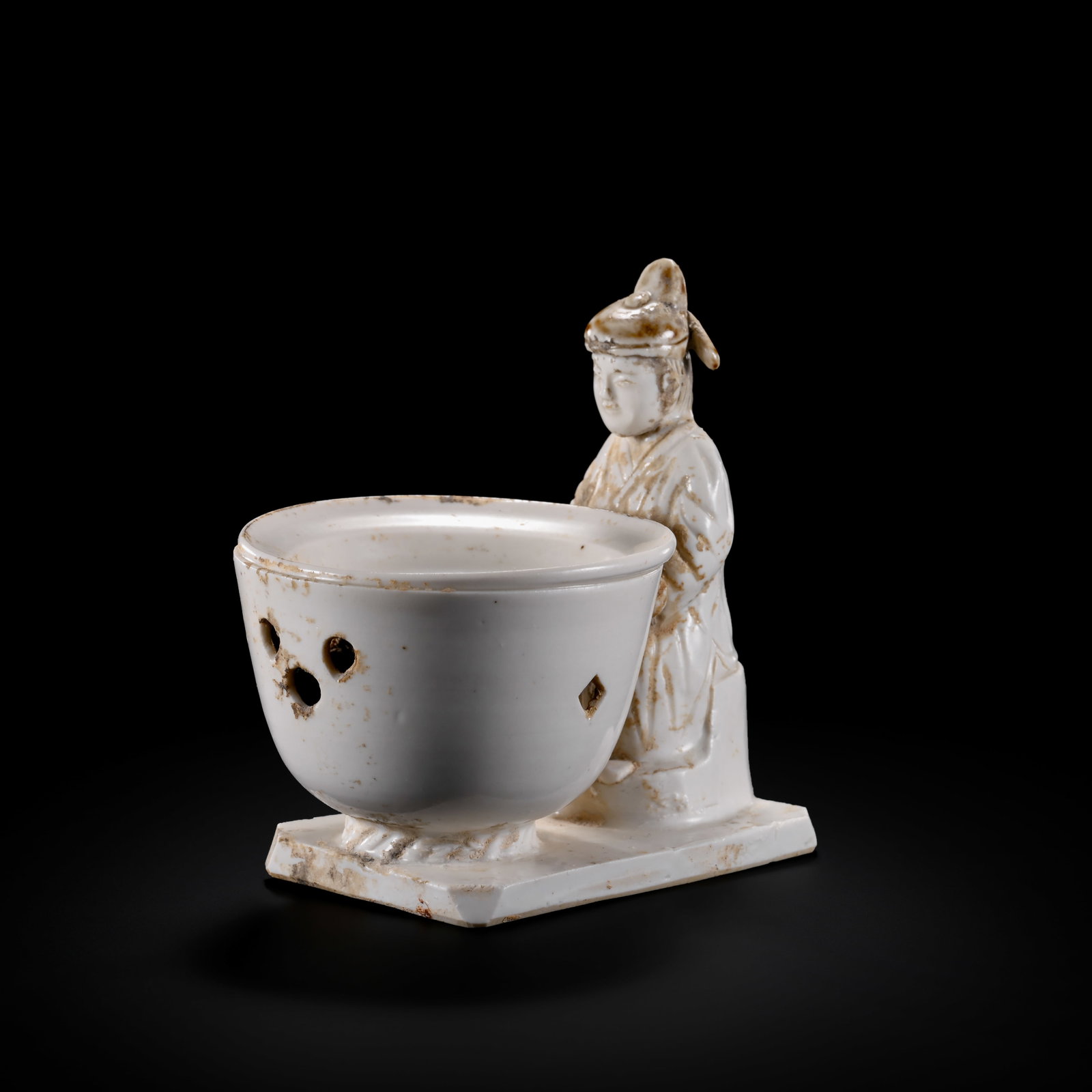 Pre-Ming Dynasty White-Glazed Attendant Holding an Incense Burner: H. 810cm.W.10cm.