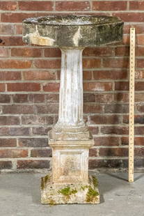 Early 20th Century Cast Stone Octagonal Birdbath on Fluted Pedestal: Circa early 20th century two part cast stone birdbath in the Neoclassical style with octagonal basin on a fluted pedestal with plinth base ornamented with recessed panels. Please note of wear consiste