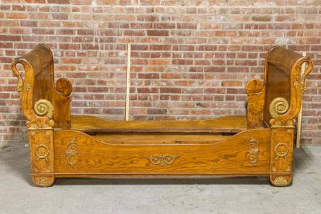 19th Century French Neoclassical Sleigh Shaped Daybed in Burled Walnut: Circa 19th century French Empire style sleigh shaped daybed in burled walnut. The bed is accented with Neoclassical motifs such as s-scroll shaped swan's heads on the corners of the head and