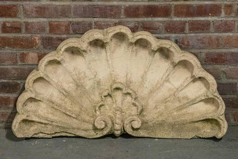 Decorative Cast Stone Scallop Shell Ornament: Decorative piece of architectural salvage in the shape of a Neoclassical style cast stone scallop shell styled in a concave fanlight shape. Please note of wear consistent with age. The piece measures