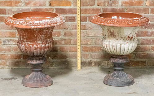 Pair of Terracotta Neoclassical Style Garden Urns: Pair of terracotta Neoclassical style garden urns in a distressed, painted finish with gadrooning on the body and egg-and-dart trim on the rim. Please note of wear consistent with age including paint