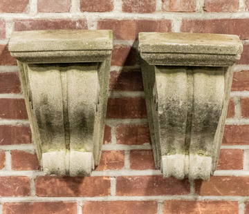 Pair of Neoclassical Style Cast Stone Corbels: Pair of Neoclassical style cast stone corbels accented with fluted, s-scroll motifs. Please note of wear consistent with age including patina and chips. The corbels measures 10.50"W x 8.50"D x 15"H.