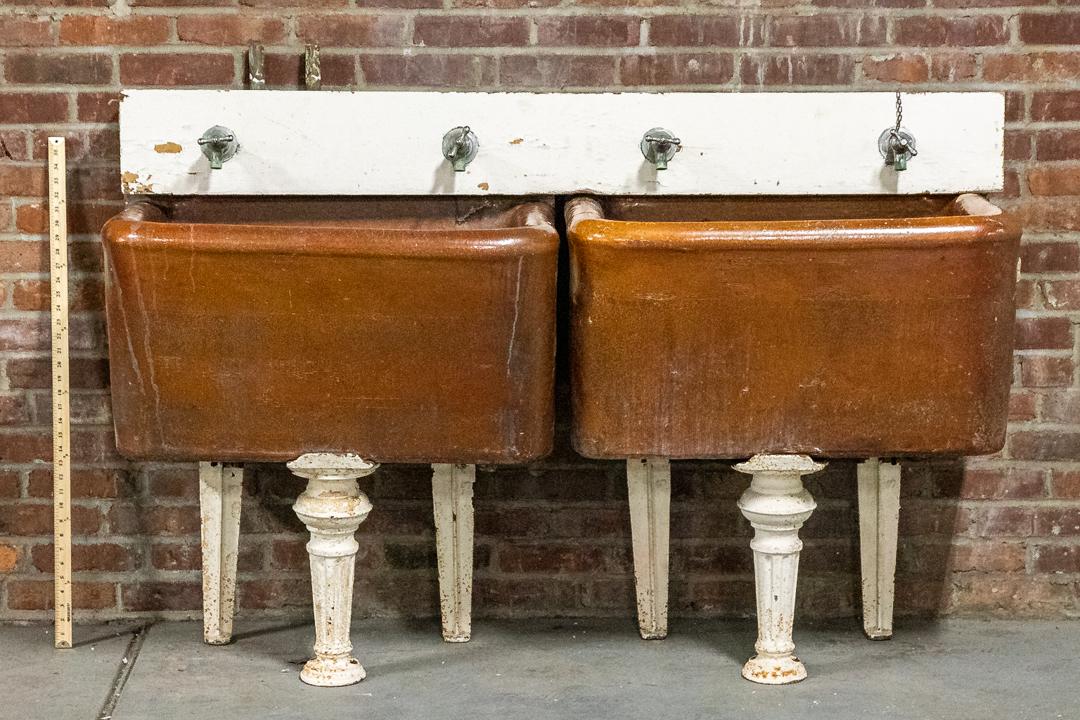 Pair of 19th Century Industrial Sized Sinks with Tripod Base by J.L. Mott's Ironworks: Pair of 19th Century Industrial sized sinks with original faucet hardware on three legged base. The front bottom leg is embellished with a fluted ball motif. Please note of wear consistent with age in