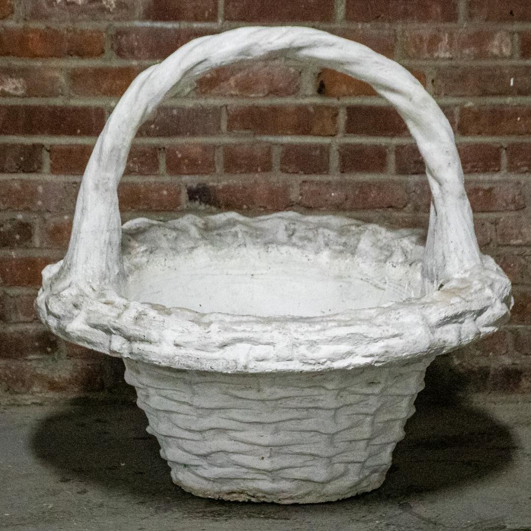 Large Scale French Concrete Faux Basket Weave Jardiniere: Large scale French Country style concrete jardiniere in the form of a faux woven basket with handle. Please note of wear consistent with age including discoloration as seen on the rim of the vessel. T