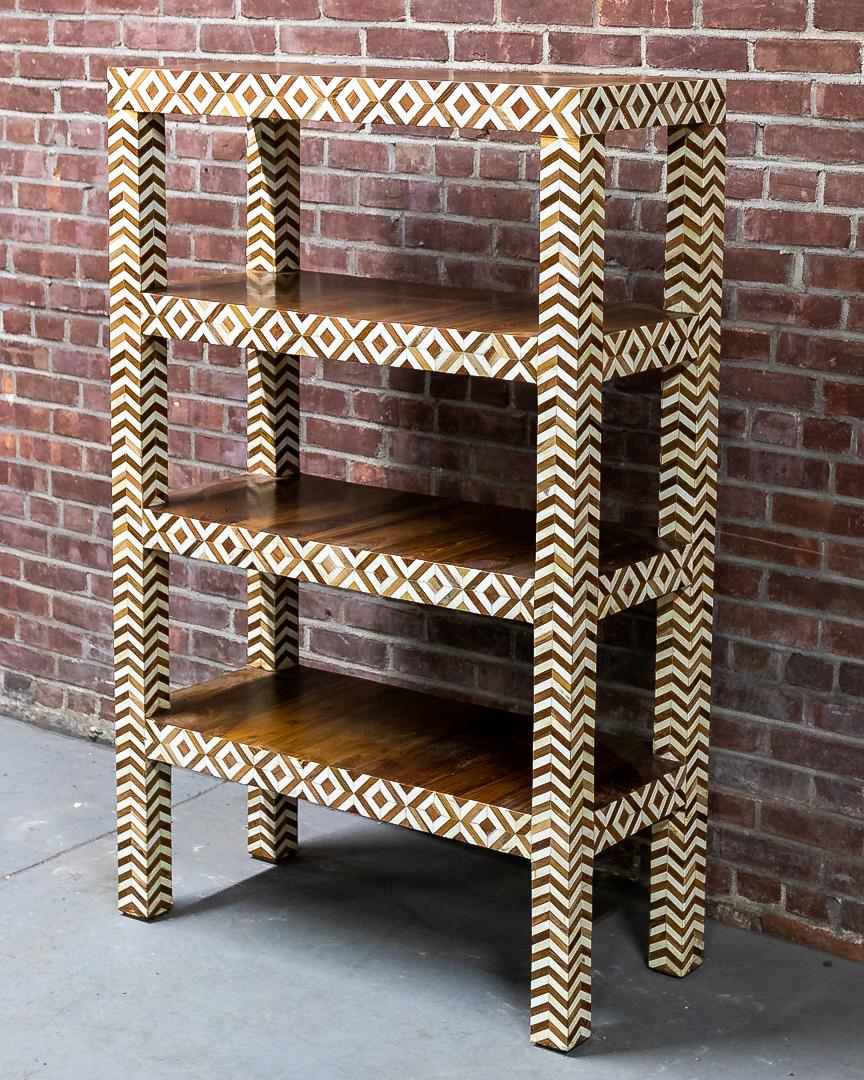 Four Tier Teak Wood Etagere with Inlaid Camel Bone Marquetry: Four tier teak wood etagere inlaid with camel bone marquetry trim on block turned feet. The piece is accented by lozenge shaped horizontal inlay and chevron shaped vertical inlay. Please note of wear 