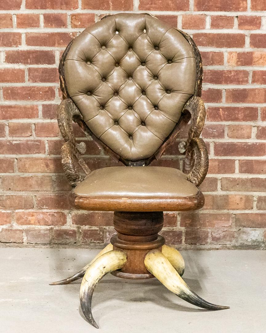 19th Century American Horn Chair with Tufted and Upholstered Seat Back: Circa 19th to early 20th century American steer or bison horn chair with upholstered seat and seat back. The chair features a tufted balloon shaped seat back. Further detail includes horn armrests and