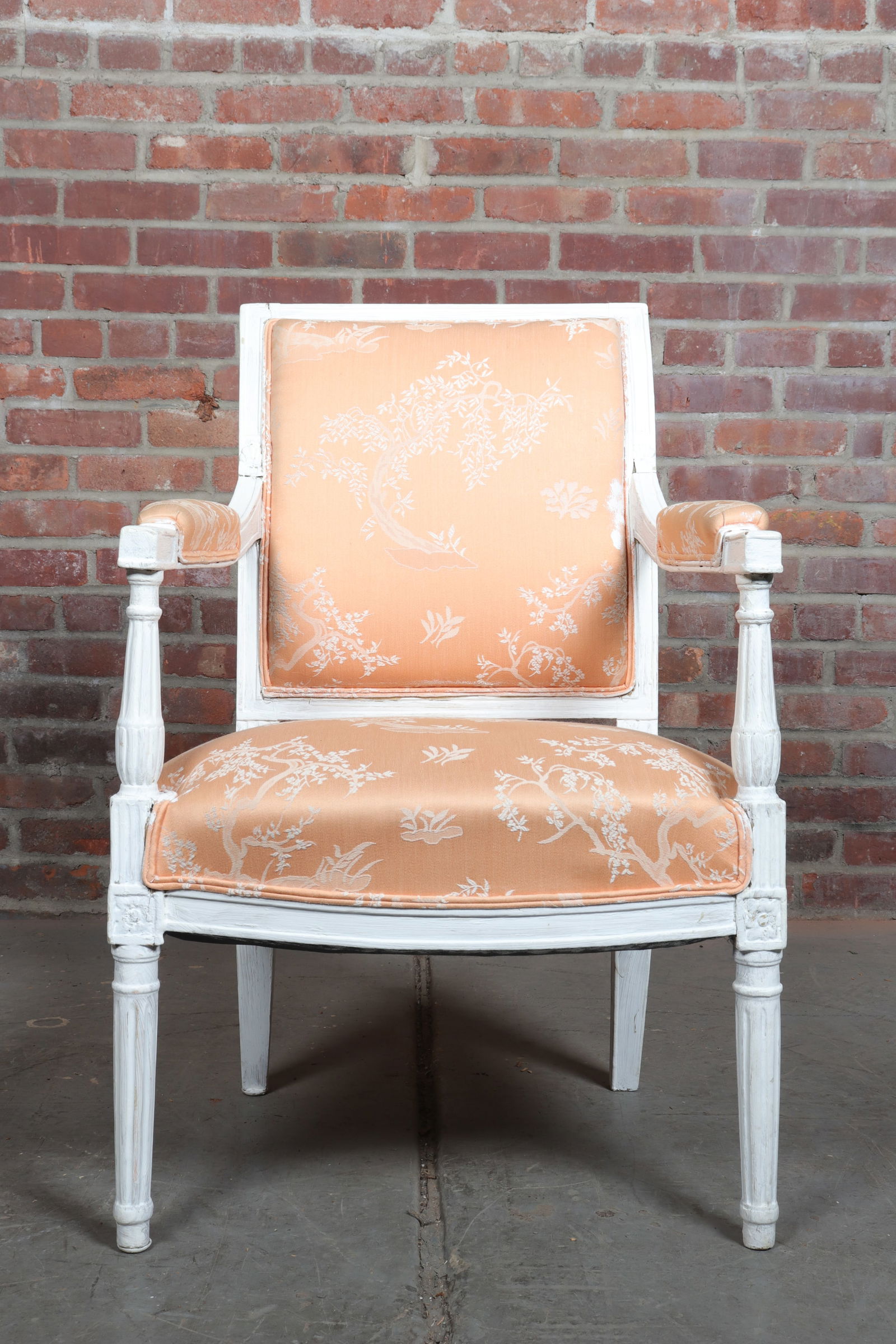 French Country Painted Bergère Chair: French country white painted bergère chair with floral salmon upholstery. Seat height 16".