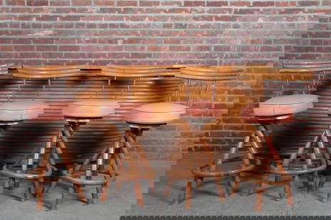 1950's Paul Frankl Bar with Four Stools: Midcentury bamboo bar and four stools designed by Paul Frankl. The bar with laminate top, central sliding cutting board, multiple upper shelves with room for storage below and a foot rail to the front