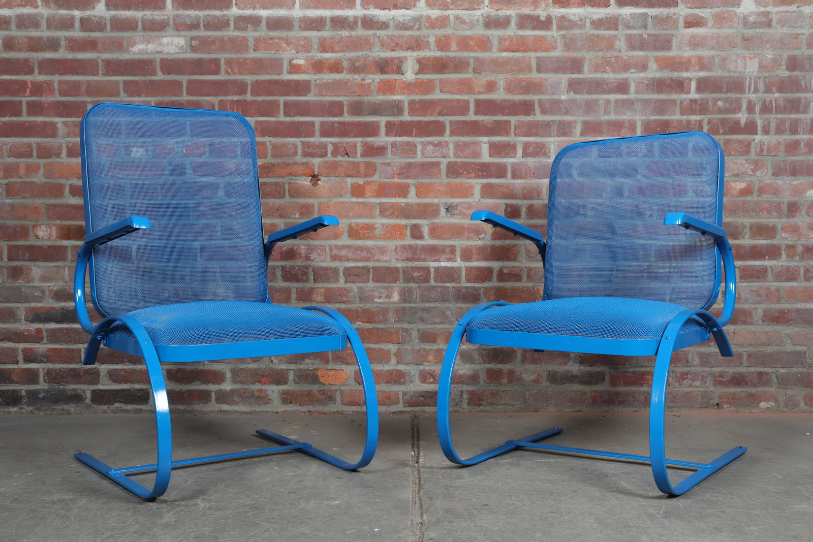 Pair of American 1940's Blue Painted Steel Bounce Chairs: Pair of American blue painted steel bounce chairs ca 1940. Rounded mesh seats and uprights with sheet metal arms, round flexible legs and flat stretchers. Seat Height 16"