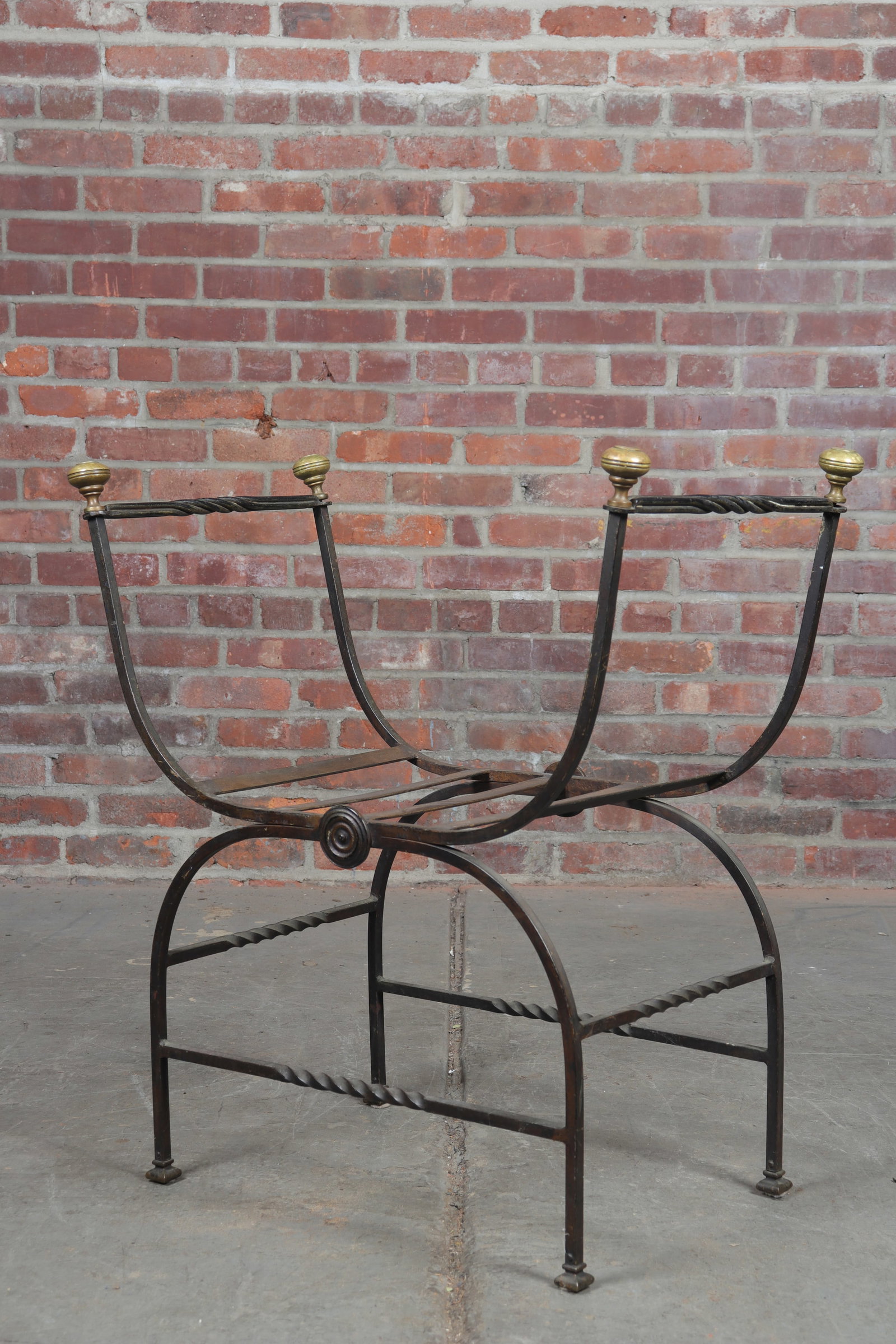 Wrought Iron Savonarola Chair: Wrought iron Savonarola chair with round brass finials and twisted iron bars and stretchers. Simple patera centered at the front and reverse. Spade feet. Seat height 16"
