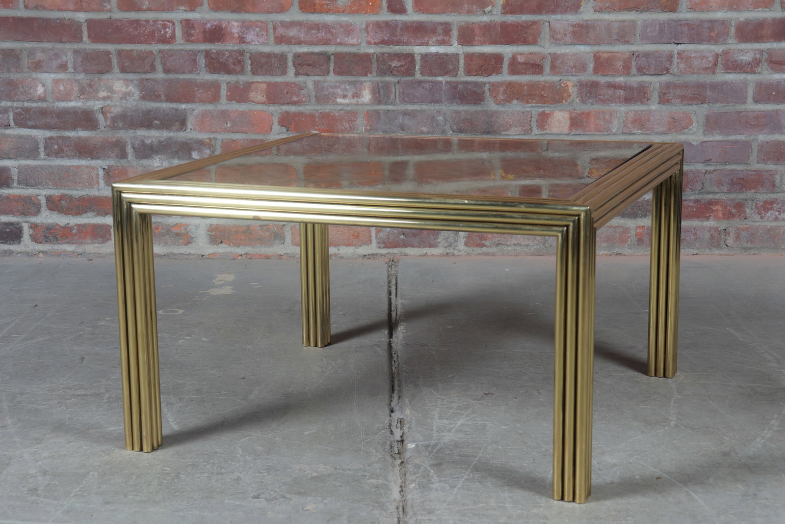 Brass and Mother of Pearl Coffee Table: Modern square tubular form brass coffee table with mother of pearl inlay and glass top.