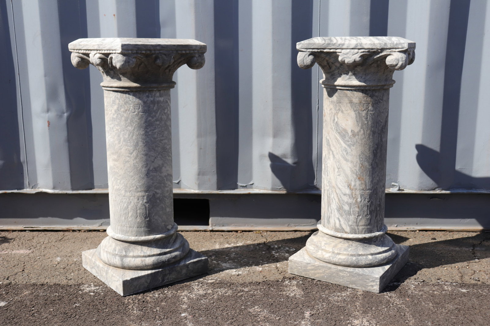Pair of Corinthian Style Stone Columns, 30": Pair of Corinthian style stone columns in typical form. Columns detach into three pieces each as pictured. This pair of columns 30" in height.