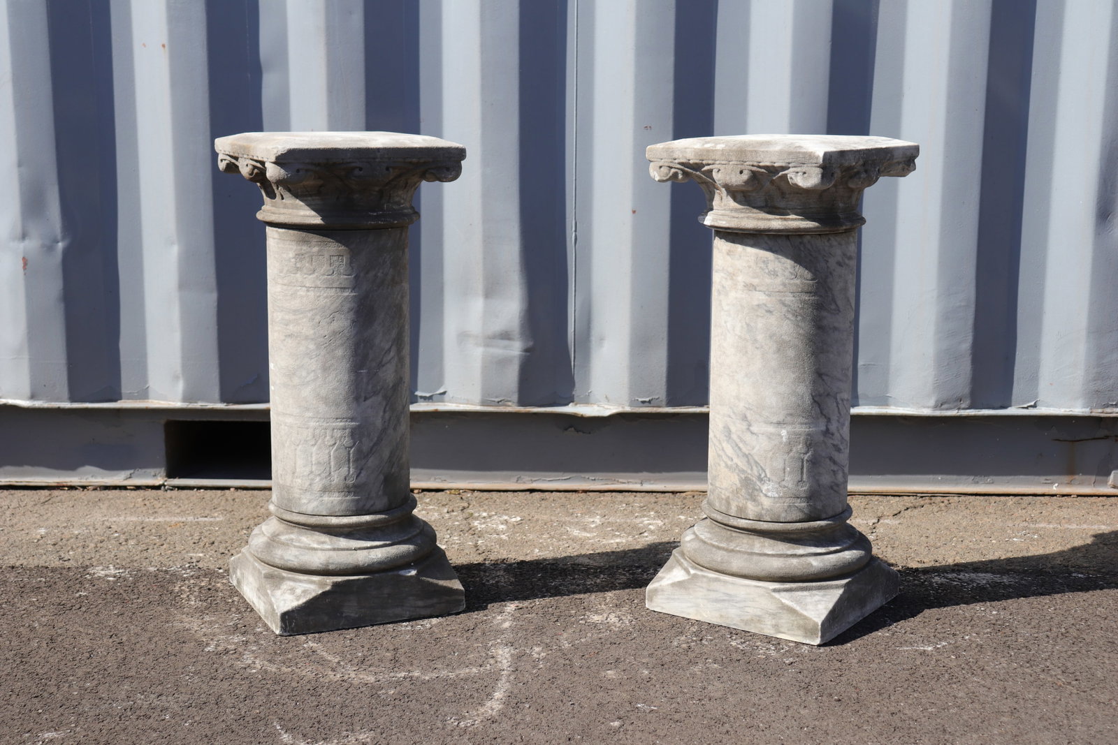 Pair of Corinthian Style Stone Columns, 28": Pair of Corinthian style stone columns in typical form. Columns detach into two pieces each as pictured. This pair of columns 28" in height.