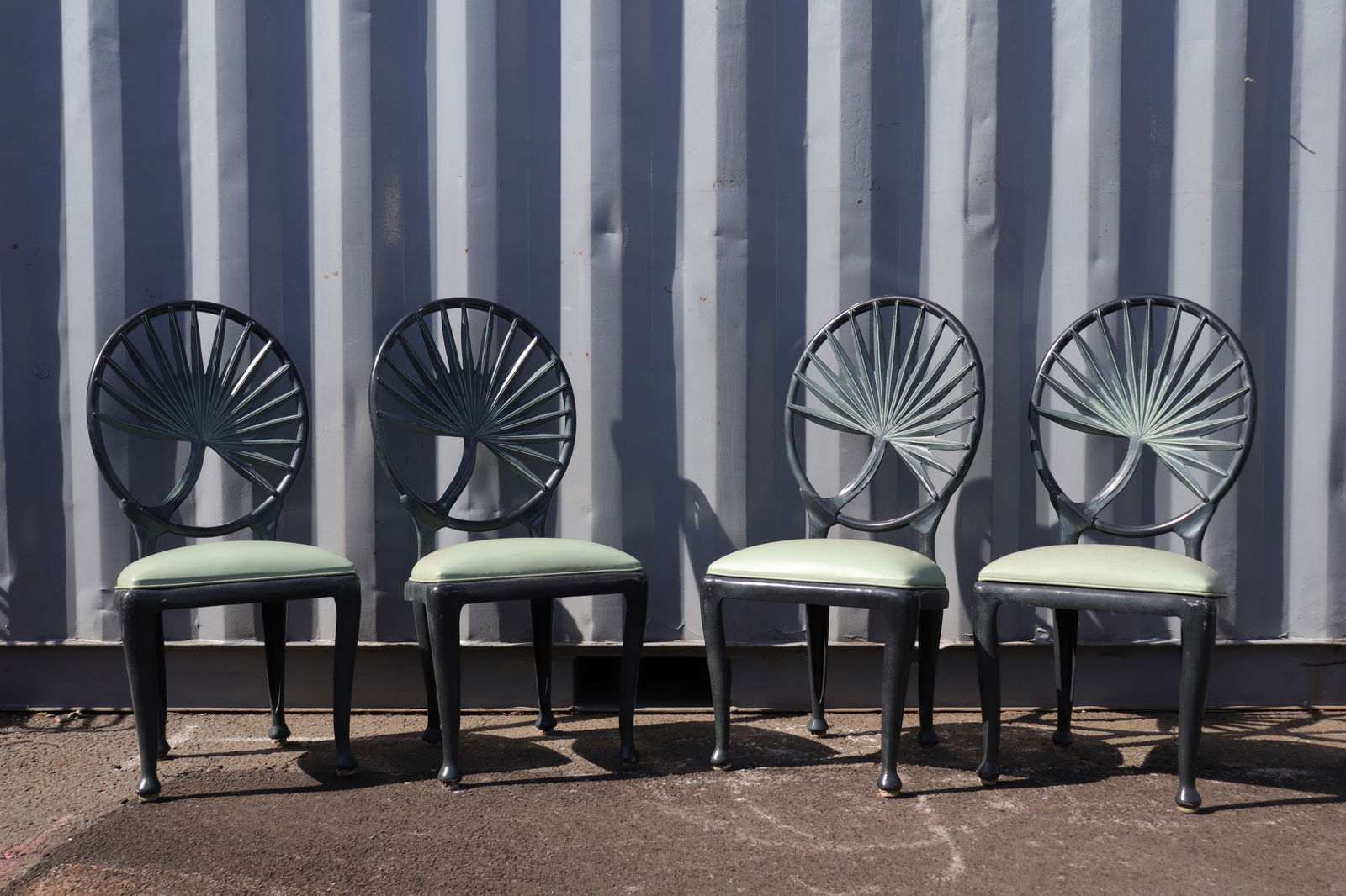 Set of Four Palm Back Tropitone Co. Chairs: Set of four palm-form medallion back patio chairs from Tropitone Co, a subsidiary of Brown Jordan. Dark green speckled frame with light green vinyl seats and club feet.