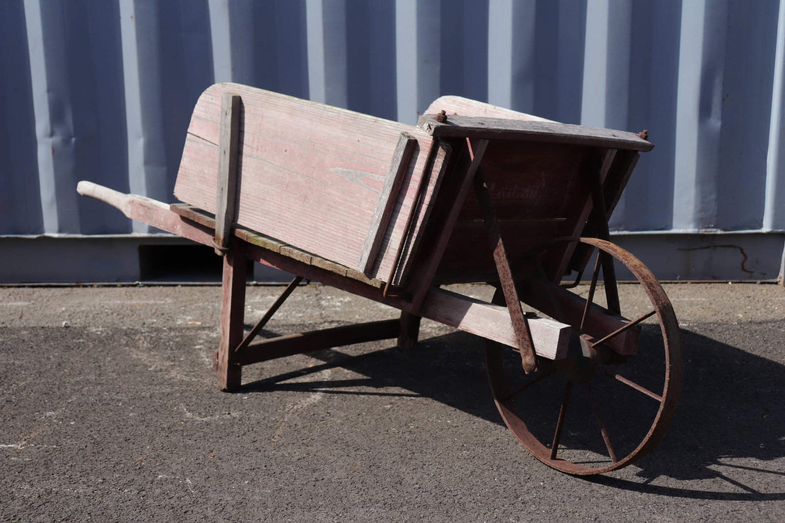 Antique Red Patinated Wheel Barrow: Antique wheelbarrow with red patina and removable sides. Original industrial printing to the front as pictured.