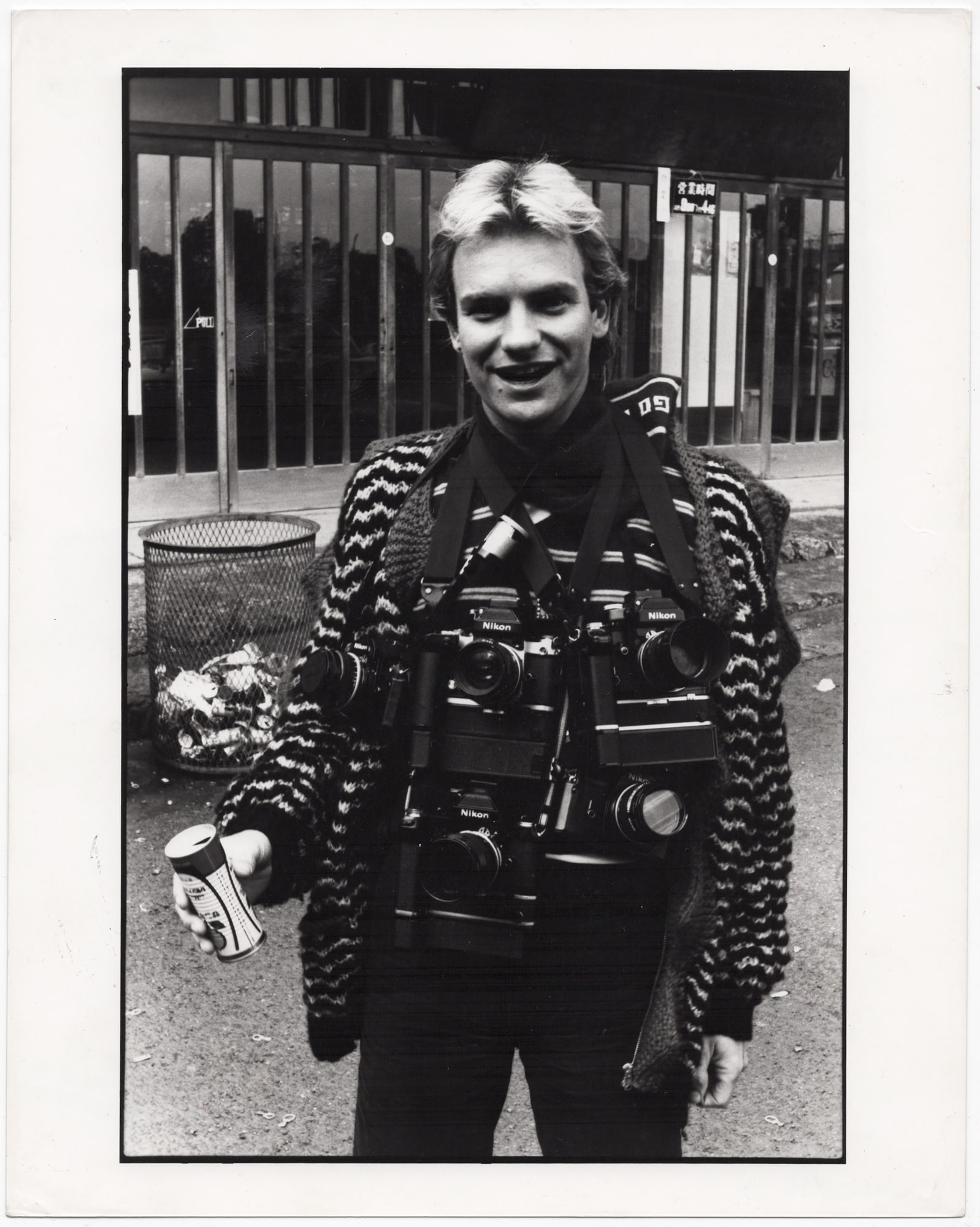 Miles Copeland* (born 1944 in London): Miles Copeland* (born 1944 in London) Sting of The Police, posing with cameras, around 1980 vintage gelatin silver print on RC paper 25,3 x 20,1 cm verso with hand-written photographer’s credit and