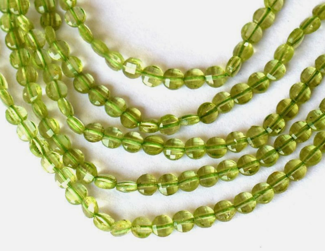 12" STRAND NATURAL PERIDOT BEADS FACETED COIN 4 MM (2 LINES): These are natural, earth mined and hand crafted with precision. Stone: Peridot, Stone Shape: Faceted Coin, Stone Size: 4mm, Width - 2 - 3mm, Length: 12", Weight: approx. 28.10 carats. The photographs