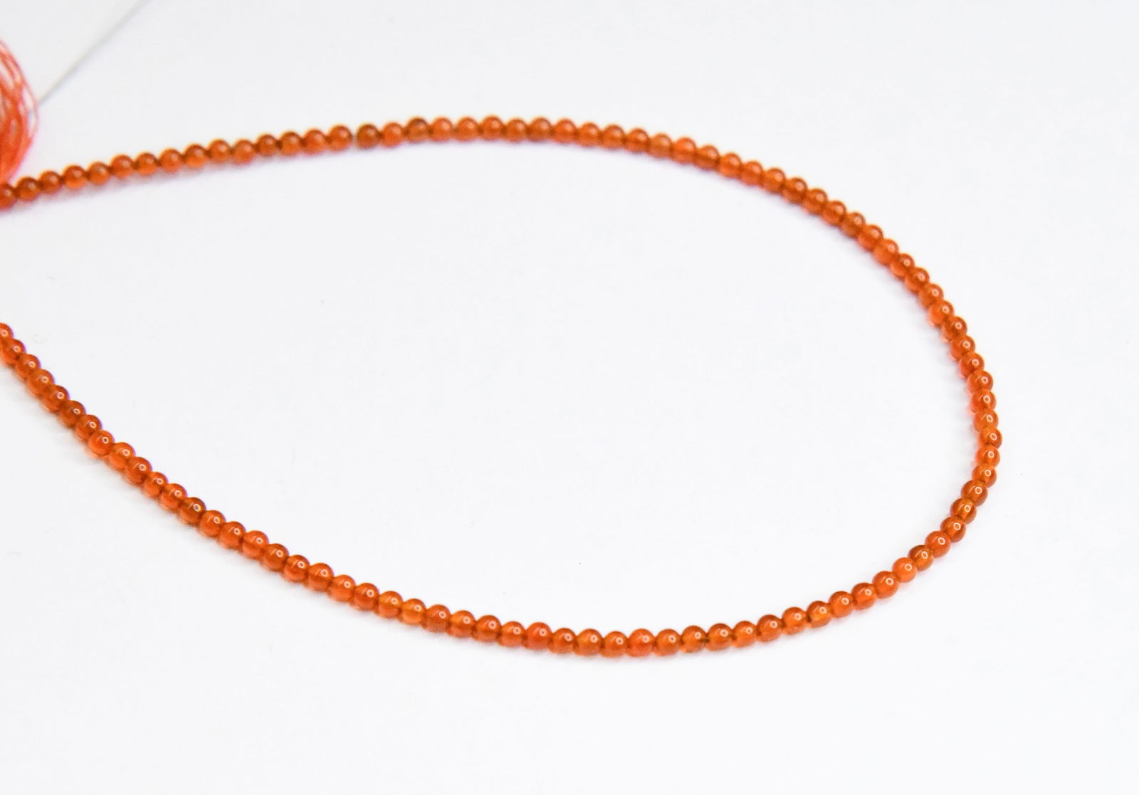 NATURAL CARNELIAN BEADS ROUND 2 MM, 8" STRAND: These are natural, earth mined and hand crafted with precision. Stone: Carnelian, Stone Shape: Round, Stone Size: 2 mm, Weight: approx. 7 carats. The photographs are generally enlarged to show the cla