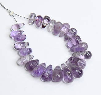 NATURAL AMETHYST BEADS BRIOLETTE 4X7 - 6X13 MM, 23 PCS: These are natural, earth mined and hand crafted with precision. Stone: Amethyst, Stone Shape: Briolette, Stone Size: 4x7 - 6x13 mm, Weight: approx. 41 carats. The photographs are generally enlarged to