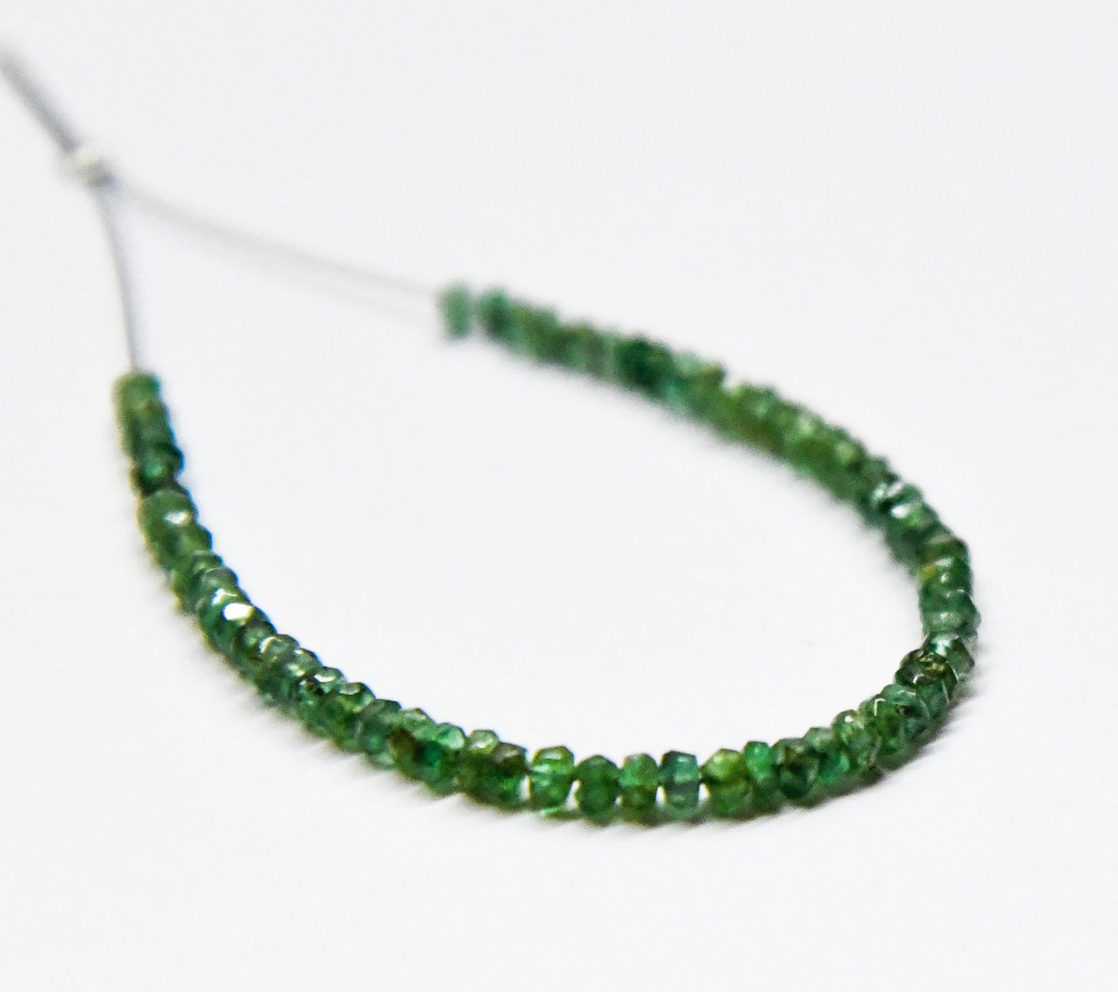 NATURAL EMERALD BEADS FACETED RONDELLE 2 - 2.5 MM, 64 PCS: These are natural, earth mined and hand crafted with precision. Stone: Emerald, Stone Shape: Rondelle, Stone Size: 2 - 2.5 mm, Width: 1 - 1.5 mm, Weight: approx. 6 carats. The photographs are generall