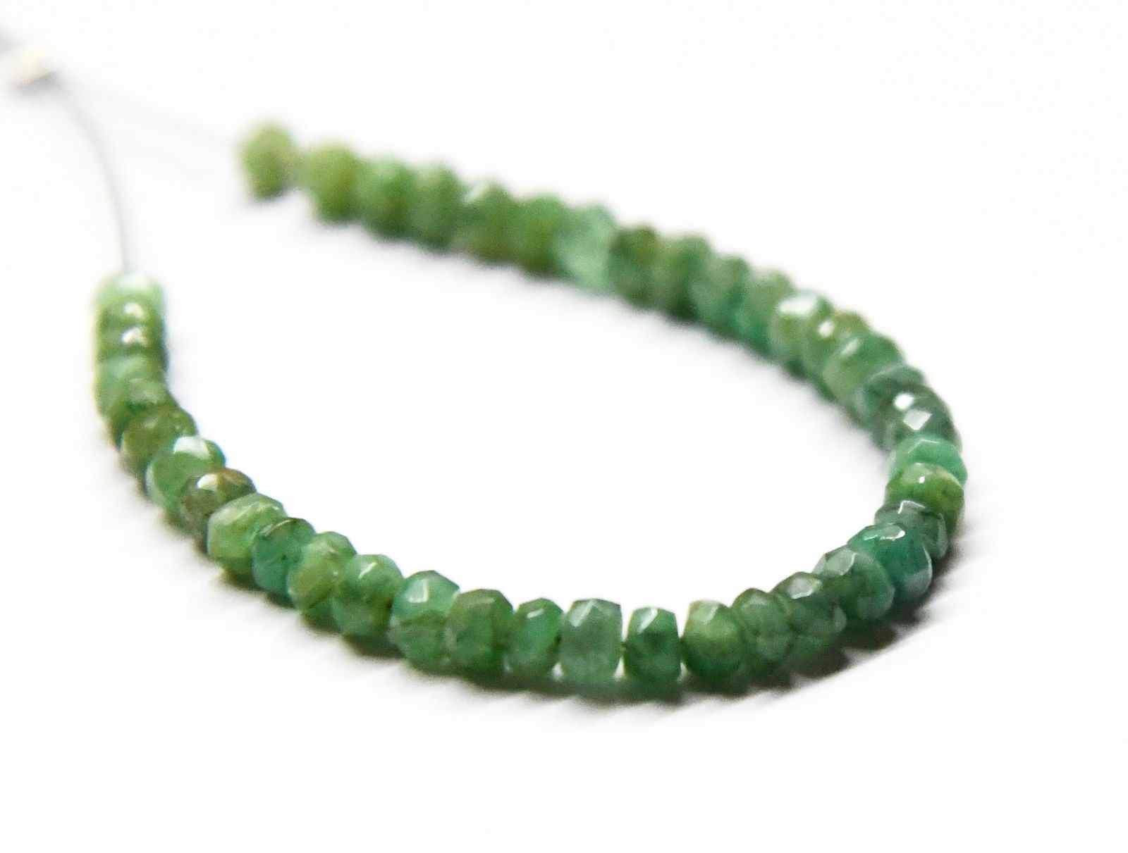 NATURAL EMERALD BEADS FACETED RONDELLE 3.5 MM, 42 PCS: These are natural, earth mined and hand crafted with precision. Stone: Emerald, Stone Shape: Faceted Rondelle, Stone Size: 3.5 mm, Width: 2 - 2.5 mm, Weight: approx. 12 carats. The photographs are gen