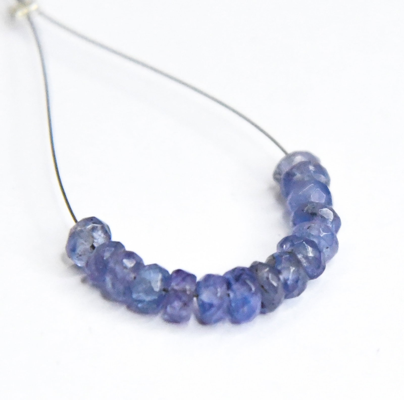 NATURAL TANZANITE BEADS FACETED RONDELLE 4 MM, 15 PCS: These are natural, earth mined and hand crafted with precision. Stone: Tanzanite, Stone Shape: Rondelle, Stone Size: 4 mm, Width: 1.5 - 2 mm, Weight: approx. 5.5 carats. The photographs are generally 