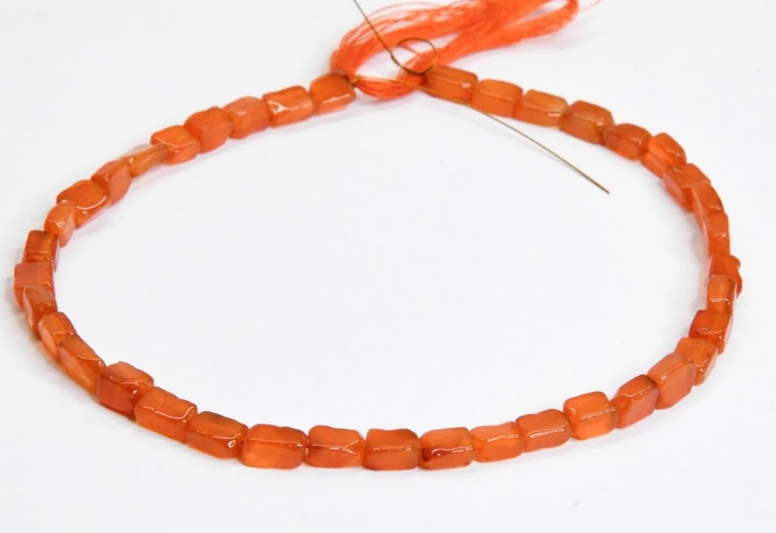 NATURAL CARNELIAN BEADS CUBE 4X5 - 5X7 MM 9.5" STRAND: These are natural, earth mined and hand crafted with precision. Stone: Carnelian, Stone Shape: Cube, Stone Size: 4x5.5 - 5x7 mm, Width: 3 - 4 mm, Weight: 42 carats. The photographs are generally enlar
