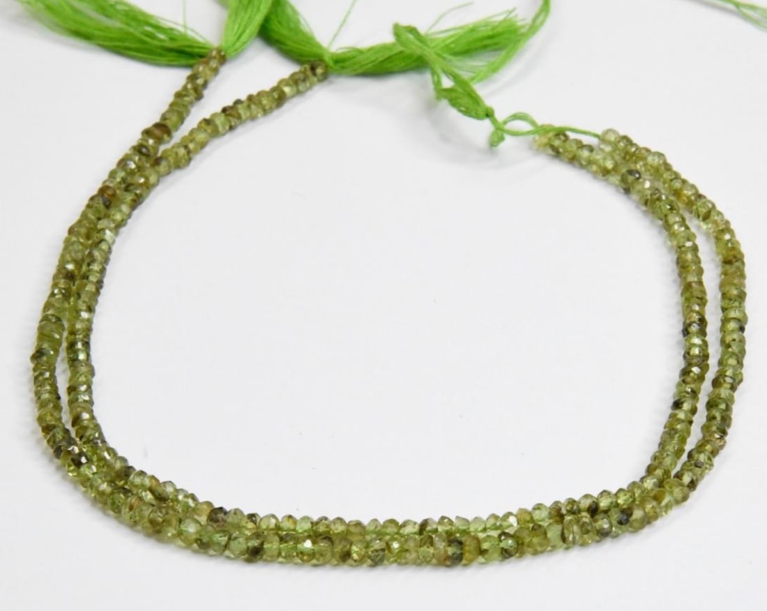 NATURAL PERIDOT BEADS FACETED RONDELLE 3 MM, 9" STRAND (2 LINES): These are natural, earth mined and hand crafted with precision. Stone: Peridot, Stone Shape: Faceted Rondelle, Stone Size: 3 mm, Width: 1.5 - 2 mm, Weight: 19 carats. The photographs are generally enl