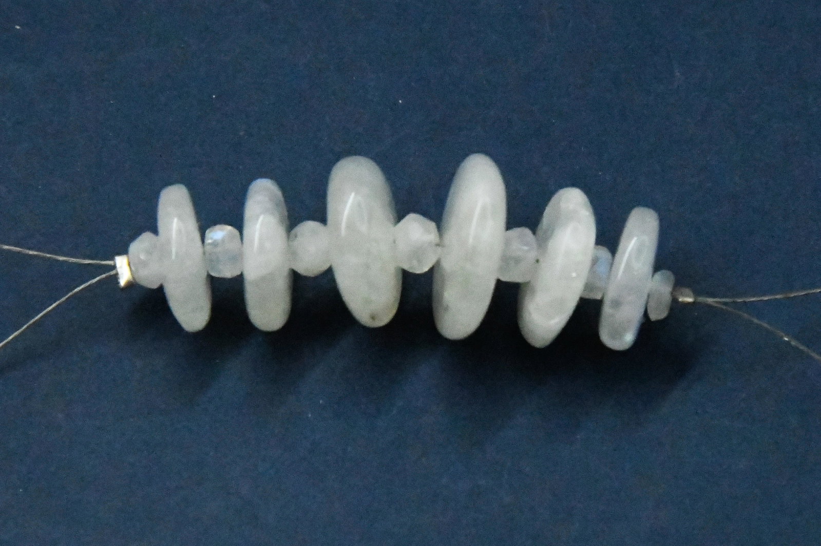 NATURAL RAINBOW MOONSTONE BEADS RONDELLE 11 - 15 MM 13 PCS: These are natural, earth mined and hand crafted with precision. Stone: Rainbow Moonstone, Stone Shape: Rondelle, Stone Size: 11 - 15 mm, Width: 1.5 - 4.5 mm, Weight: approx. 35 carats. The photographs