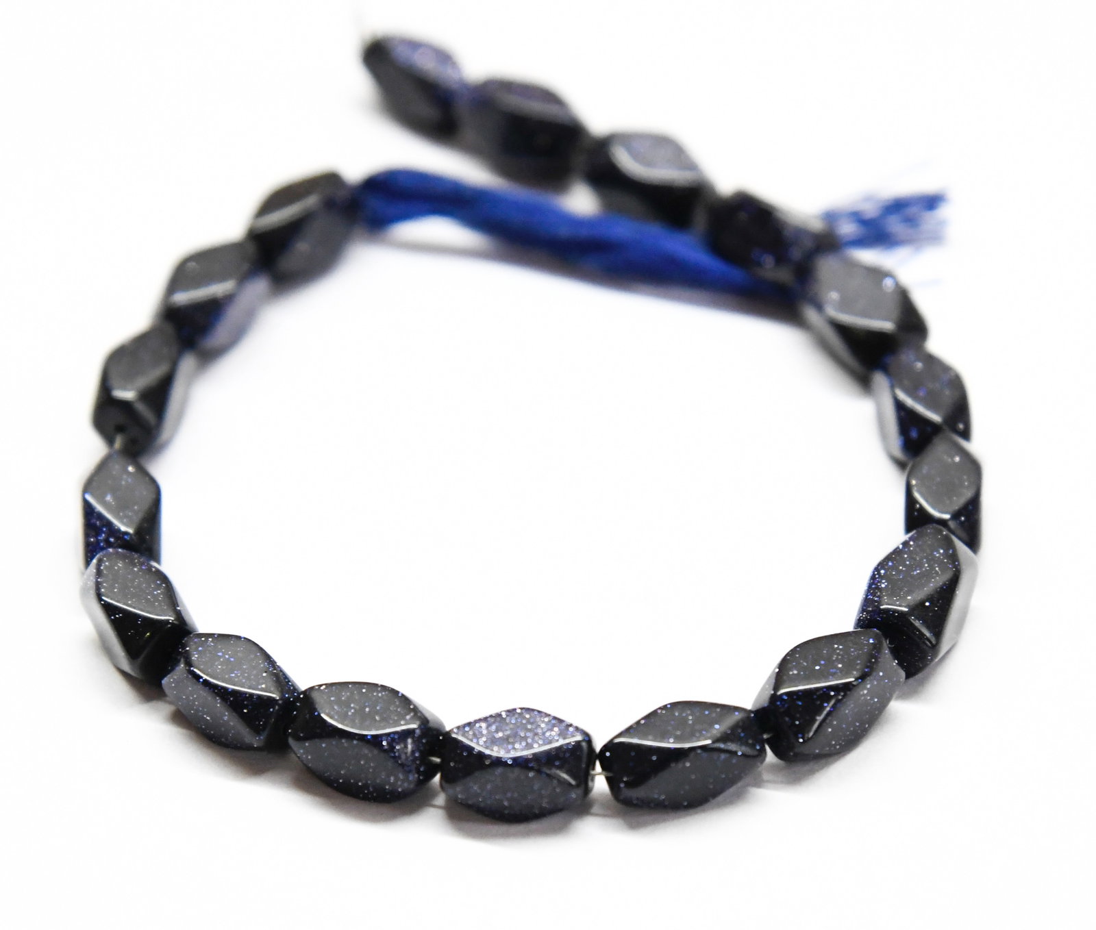 NATURAL BLUE GOLDSTONE BEADS FACETED CUBE 5X9 - 9X10 MM, 6.5" LINE: These are natural, earth mined and hand crafted with precision. Stone: Blue Goldstone, Stone Shape: Faceted Cube, Stone Size: 5x9 - 9.5x10 mm, Weight: approx. 57 carats. The photographs are generally 