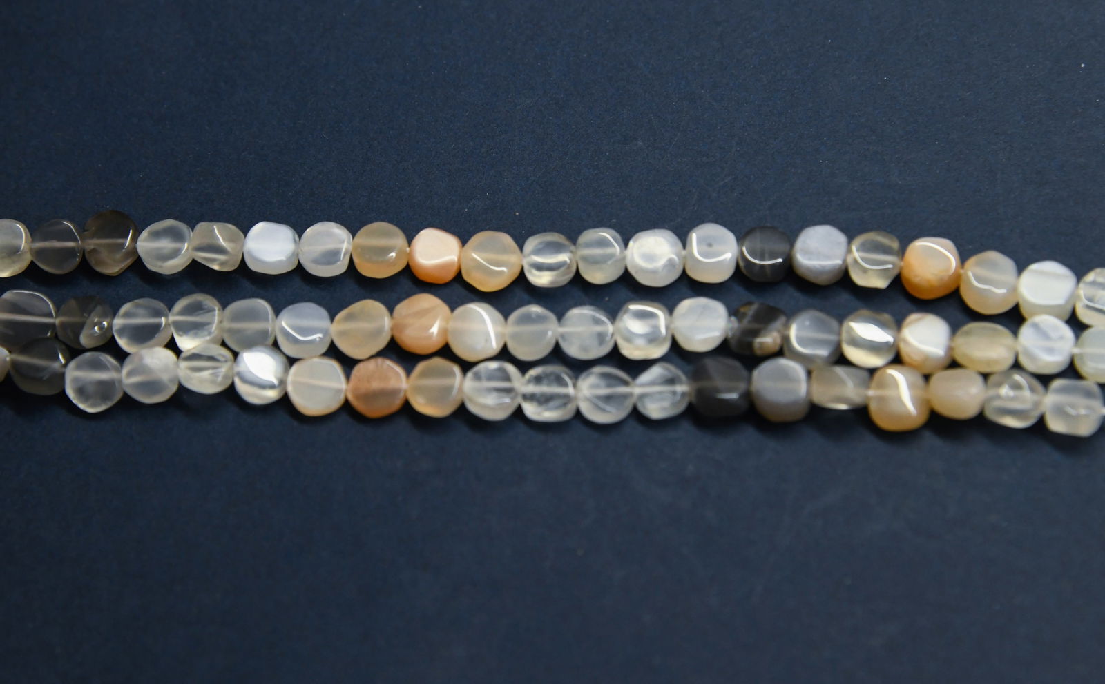 NATURAL MULTI MOONSTONE BEADS COIN 6 - 7 MM, 9.5" STRAND - (3 LINES): These are natural, earth mined and hand crafted with precision. Stone: Multi Moonstone, Stone Shape: Coin, Stone Size: 6 - 7 mm, Width: 2 - 4 mm, Weight: approx. 58 carats. The photographs are general