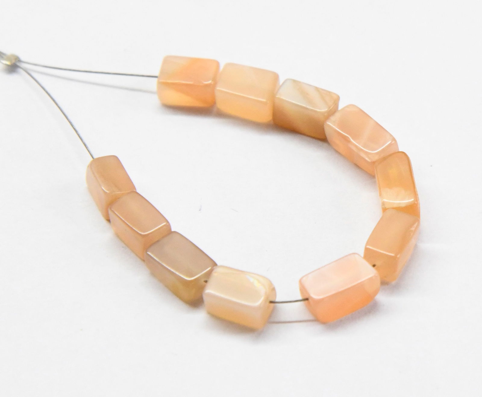 NATURAL PEACH MOONSTONE BEADS CUBE 5X6 - 5X7 MM, 11 PCS (2 TASSELS): These are natural, earth mined and hand crafted with precision. Stone: Peach Moonstone, Stone Shape: Cube, Stone Size: 5x6 - 5x7 mm, Width: 4 - 4.5 mm, Weight: approx. 11 carats. The photographs are g
