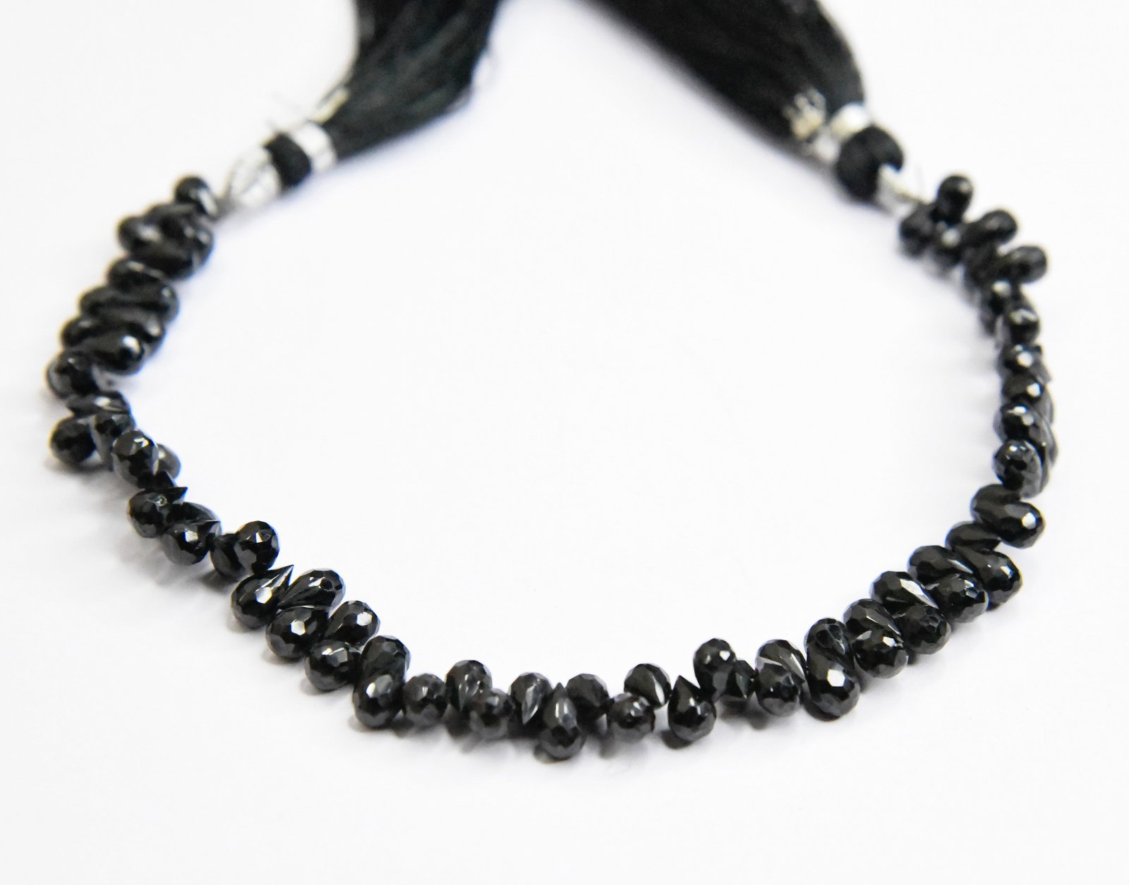 8" STRAND NATURAL BLACK SPINEL BEADS FACETED BRIOLETTE 4X6 - 4X7 MM (1 LINE): These are natural, earth mined and hand crafted with precision. Stone: Black Spinel, Stone Shape: Faceted Briolette, Stone Size: 4x6 - 4x7 mm, Length: 8", Weight: approx. 80 carats. The photographs ar