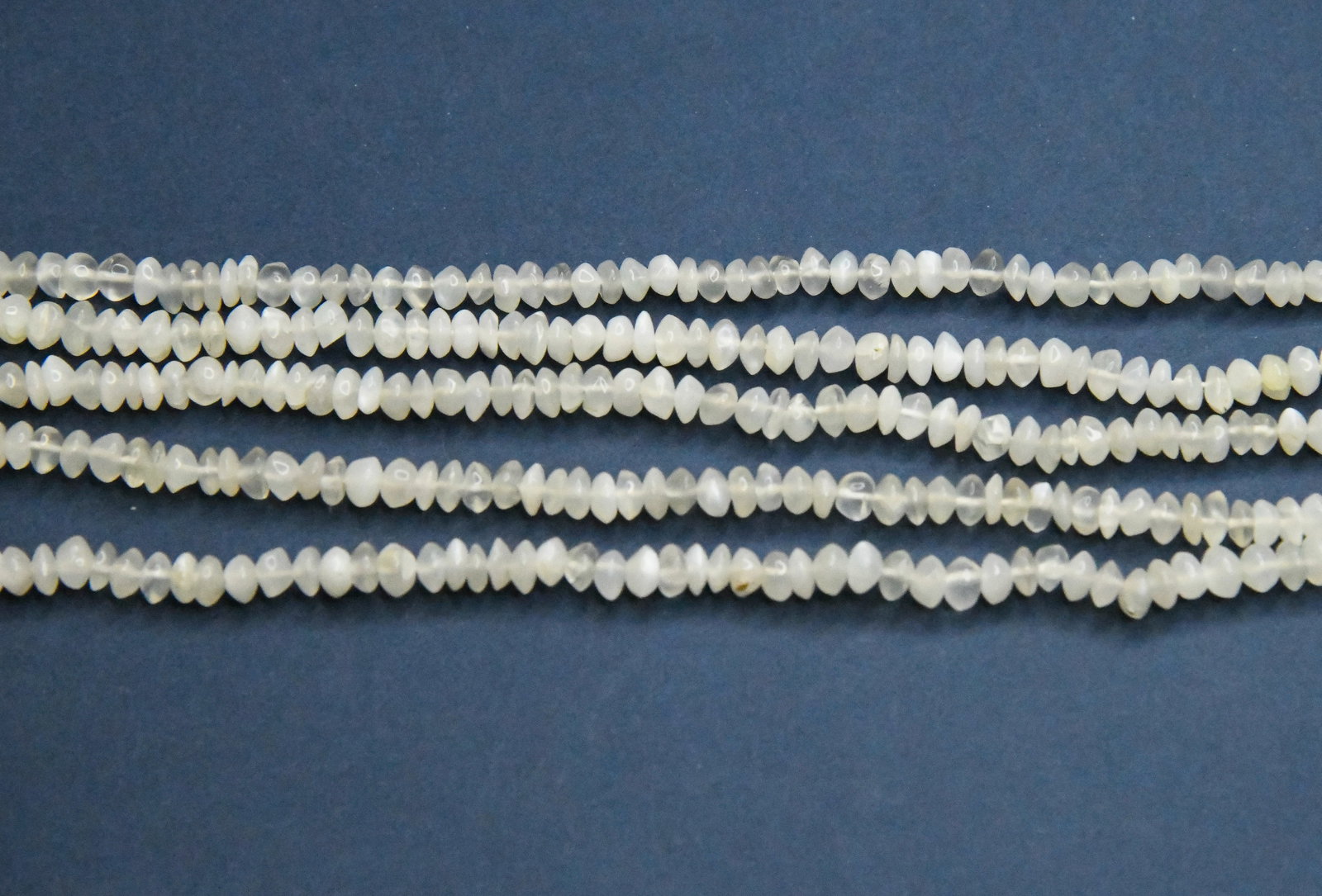 14" STRAND NATURAL WHITE MOONSTONE BEADS RONDELLE 4.5 - 5 MM (3 LINES): These are natural, earth mined and hand crafted with precision. Stone: White Moonstone, Stone Shape: Rondelle, Stone Size: 4.5 - 5 mm, Length: 14", Weight: approx. 52 carats. The photographs are enlar