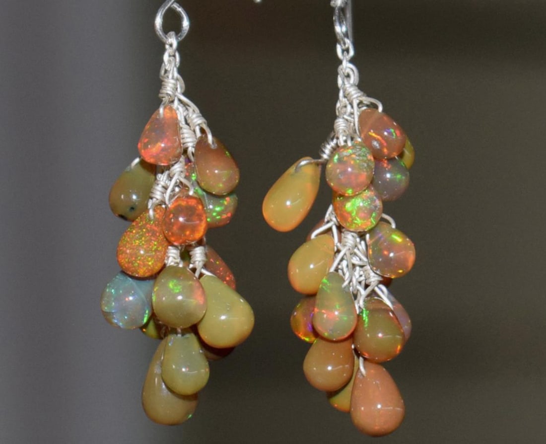 SOLID 925 STERLING SILVER EARRINGS - NATURAL ETHIOPIAN OPAL BEADS 1 5/8": These are natural, earth mined and hand crafted with precision. Stone: Ethiopian Opal, Shape: Briolette, Size: 4x5 - 4.5x7 mm, Length: 1 5/8", Weight: approx. 22.7 carats. The photographs are enlarged