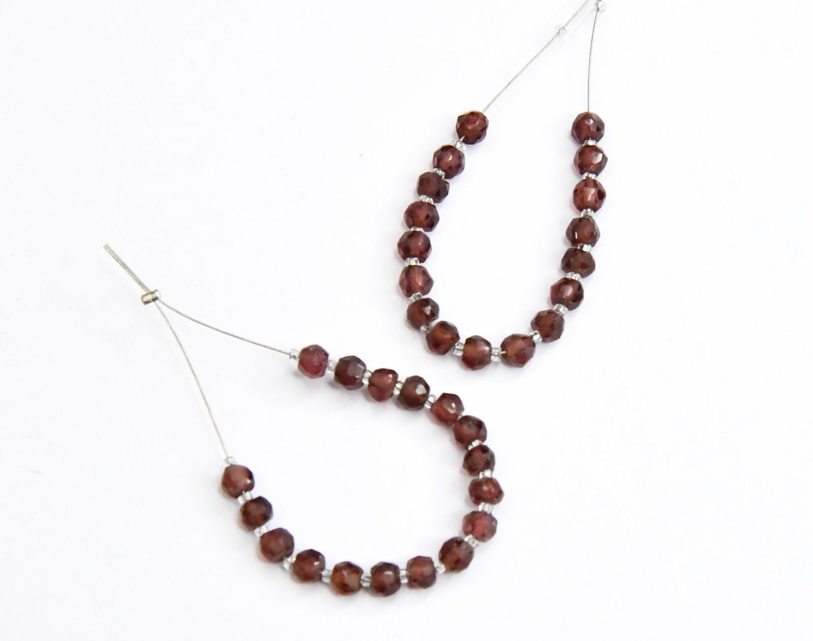 NATURAL GARNET BEADS FACETED RONDELLE 4 - 4.5 MM, 17 PCS (7 TASSELS): These are natural, earth mined and hand crafted with precision. Stone: Garnet, Stone Shape: Faceted Rondelle, Stone Size: 4 - 4.5 mm, Width: 2 - 3 mm, Weight: approx. 11 cts. The photographs are enlar