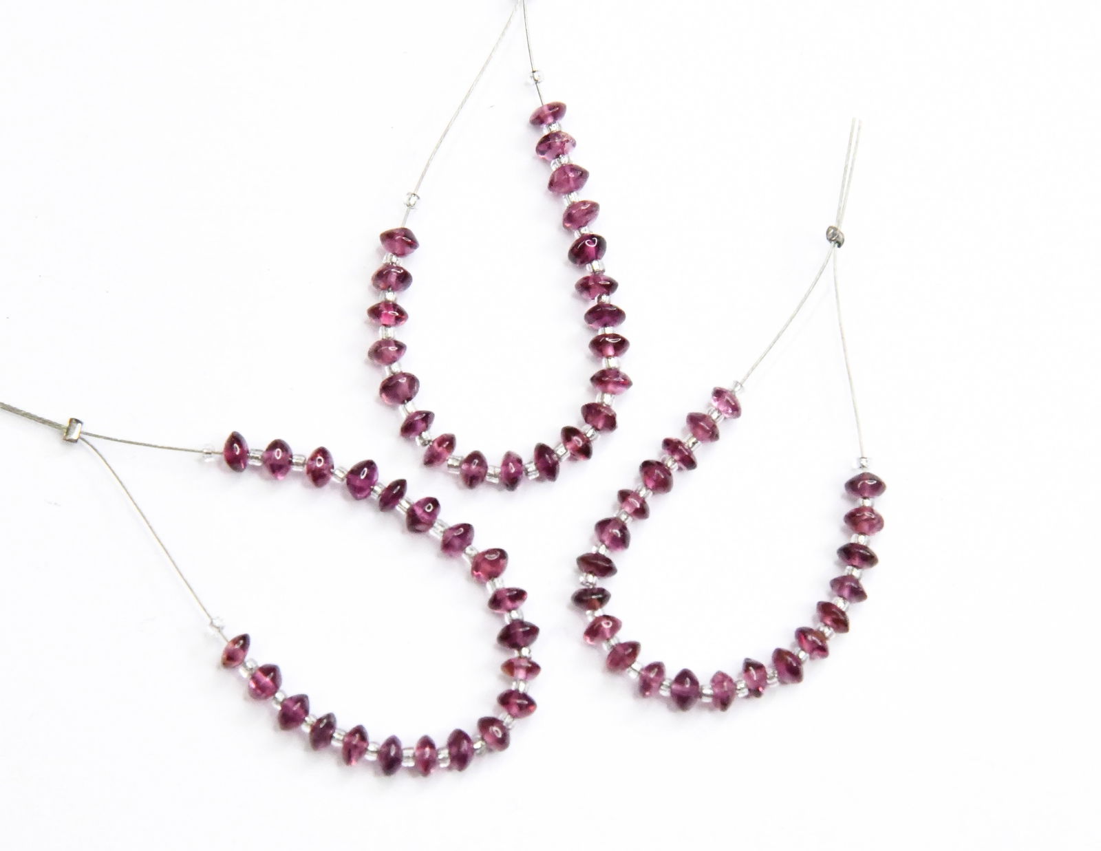 NATURAL GARNET BEADS RONDELLE 3.5 - 4 MM, 21 PCS (3 TASSELS): These are natural, earth mined and hand crafted with precision. Stone: Garnet, Stone Shape: Rondelle, Stone Size: 3.5 - 4 mm, Width: 1.5 - 2.5 mm, Weight: approx. 7.66 cts. The photographs are enlarge
