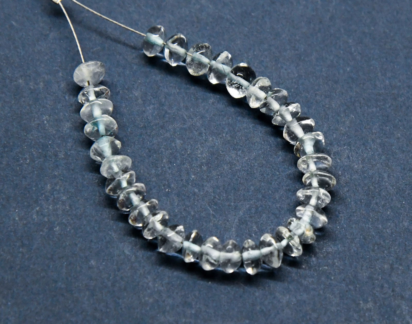 NATURAL BLUE TOPAZ BEADS (DYED) RONDELLE 4.5 - 5 MM, 32 PCS: These are natural, earth mined and hand crafted with precision. Stone: Blue Topaz (Dyed), Stone Shape: Rondelle, Stone Size: 4.5 - 5 mm, Width: 2.5 - 4 mm, Weight: approx. 18 carats. The photographs a