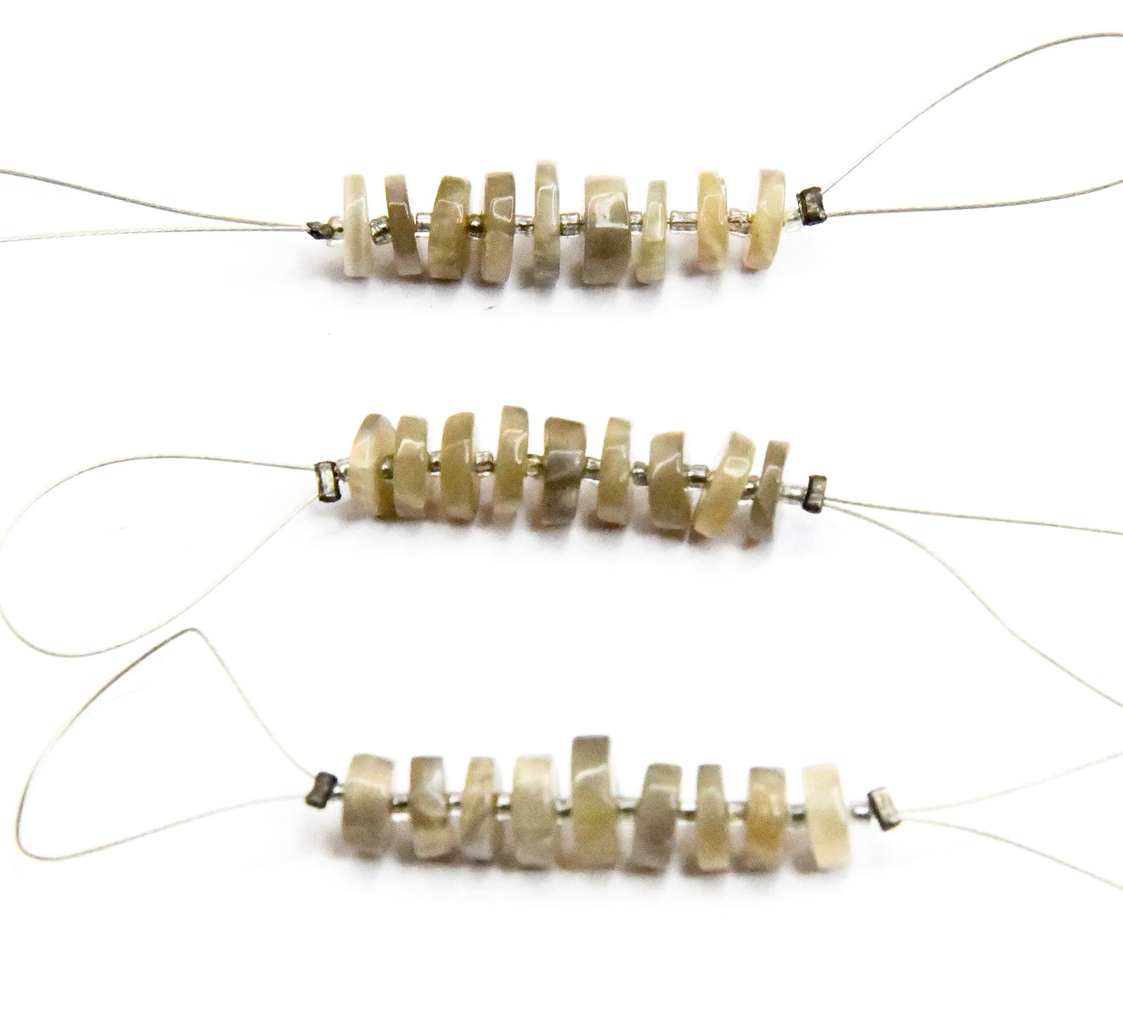 NATURAL GREY MOONSTONE BEADS TYRE 6 - 7 MM, 9 PCS (5 TASSELS): These are natural, earth mined and hand crafted with precision. Stone: Grey Moonstone, Stone Shape: Tyre, Stone Size: 6 - 7 mm, Width: 1.5 - 2 mm, Weight: approx. 5.40 cts. The photographs are enlarge