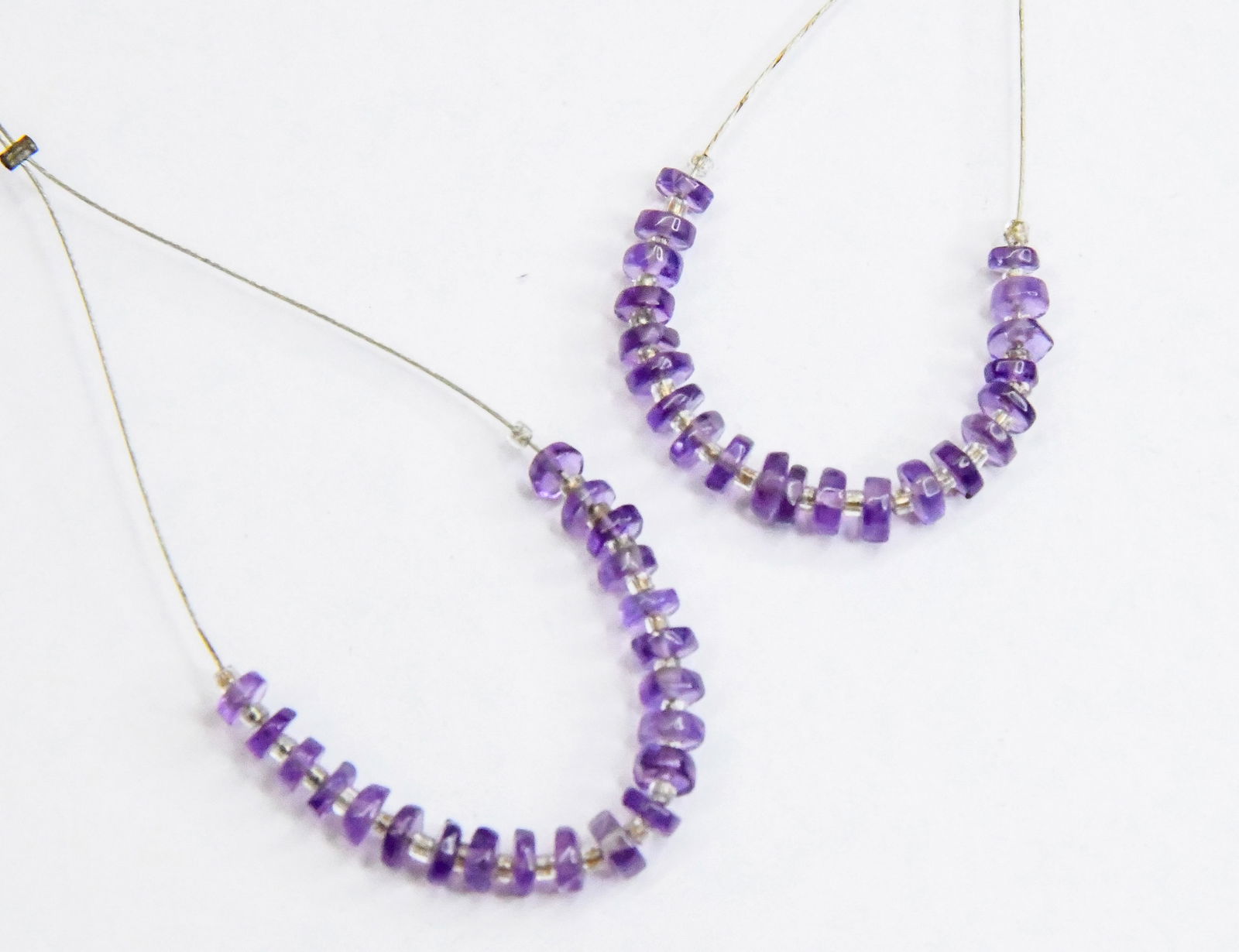 NATURAL AMETHYST BEADS TYRE 3.5 - 4 MM 21 PCS (2 TASSELS): These are natural, earth mined and hand crafted with precision. Stone: Amethyst, Stone Shape: Tyre, Stone Size: 3.5 - 4 mm Width: 1.5 - 2 mm, Weight: approx. 5 carats. The photographs are enlarged to