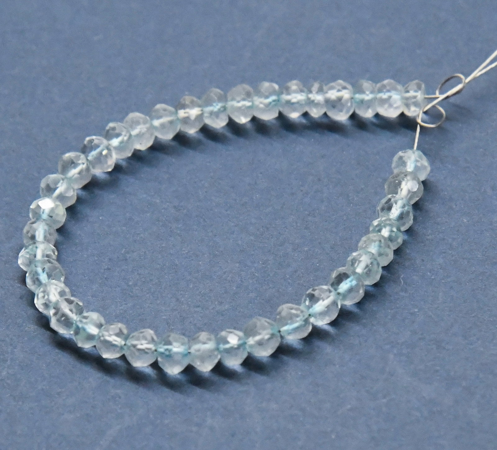 NATURAL BLUE TOPAZ BEADS (DYED) FACETED RONDELLE 4.5 MM, 38 PCS: These are natural, earth mined and hand crafted with precision. Stone: Blue Topaz (Dyed), Stone Shape: Faceted Rondelle, Stone Size: 4.5 mm, Width: 2 - 2.5 mm, Weight: approx. 38 carats. The photograp