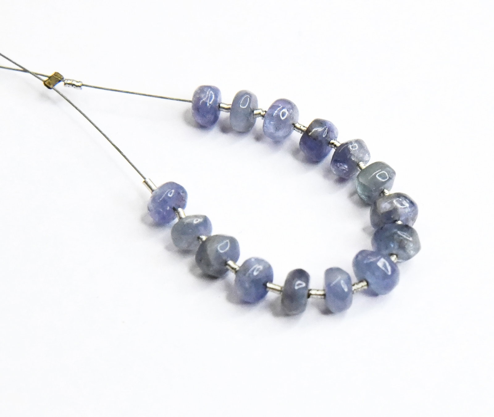NATURAL TANZANITE BEADS RONDELLE 5 - 5.5 MM 15 PCS (4 TASSELS): These are natural, earth mined and hand crafted with precision. Stone: Tanzanite, Stone Shape: Rondelle, Stone Size: 5 - 5.5 mm, Width: 2 - 3 mm, Weight: approx. 13.20 carats. The photographs are enla