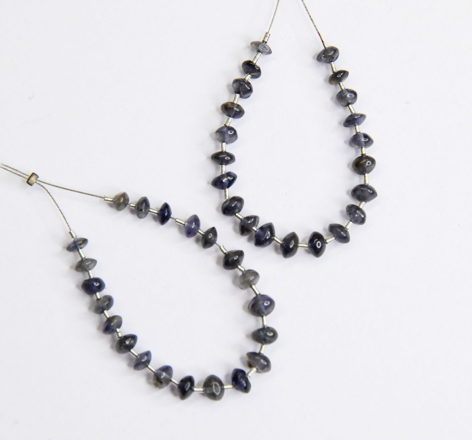 NATURAL IOLITE BEADS RONDELLE 4 - 5 MM 21 PCS (4 TASSELS): These are natural, earth mined and hand crafted with precision. Stone: Iolite, Stone Shape: Rondelle, Stone Size: 4 - 5 mm, Width: 2 - 3 mm, Weight: approx. 8 carats. The photographs are enlarged to s