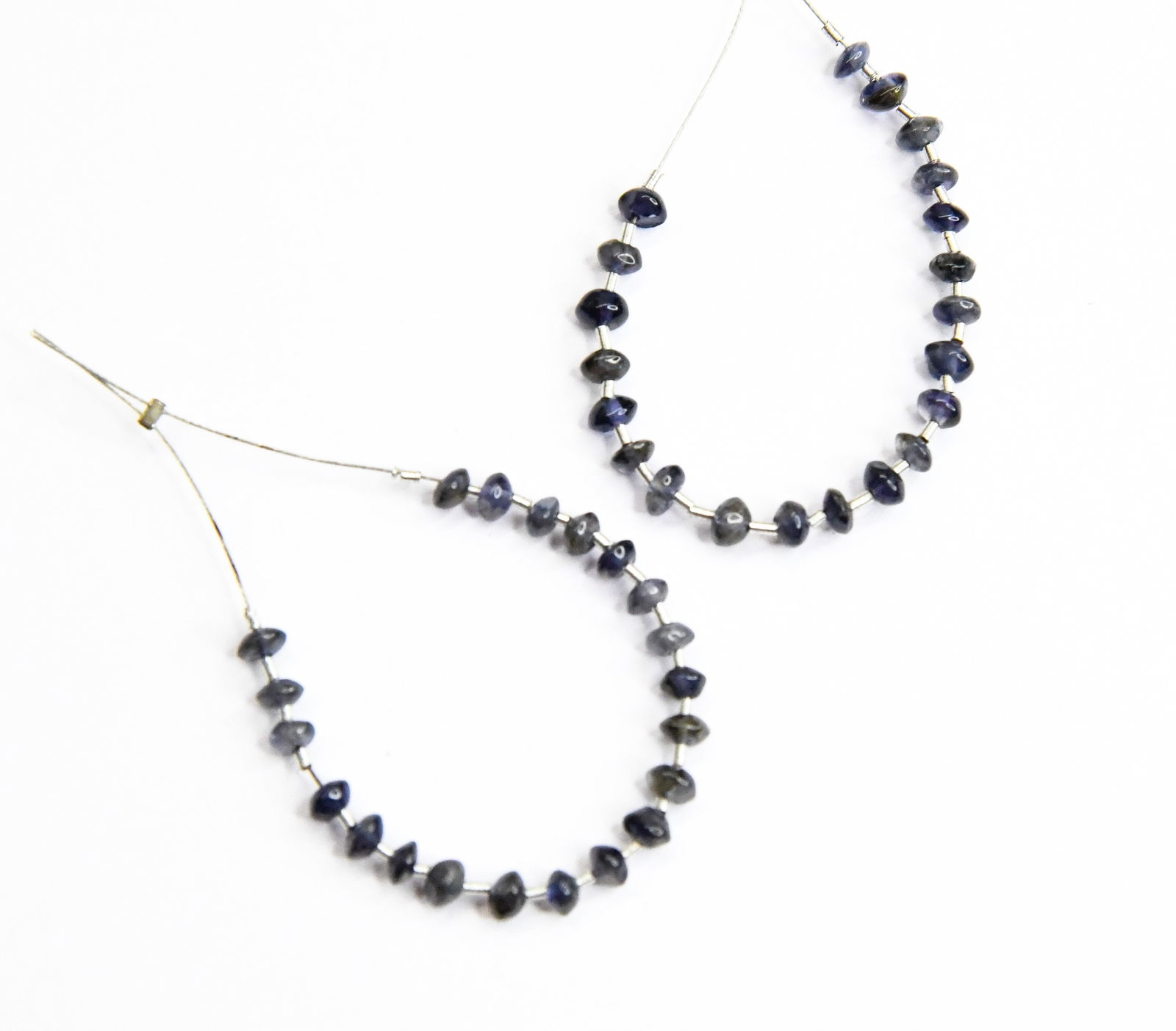 NATURAL IOLITE BEADS RONDELLE 3.5 MM 21 PCS (5 TASSELS): These are natural, earth mined and hand crafted with precision. Stone: Iolite, Stone Shape: Rondelle, Stone Size: 3.5 mm, Width: 2 - 3 mm, Weight: approx. 5 carats. The photographs are enlarged to sho