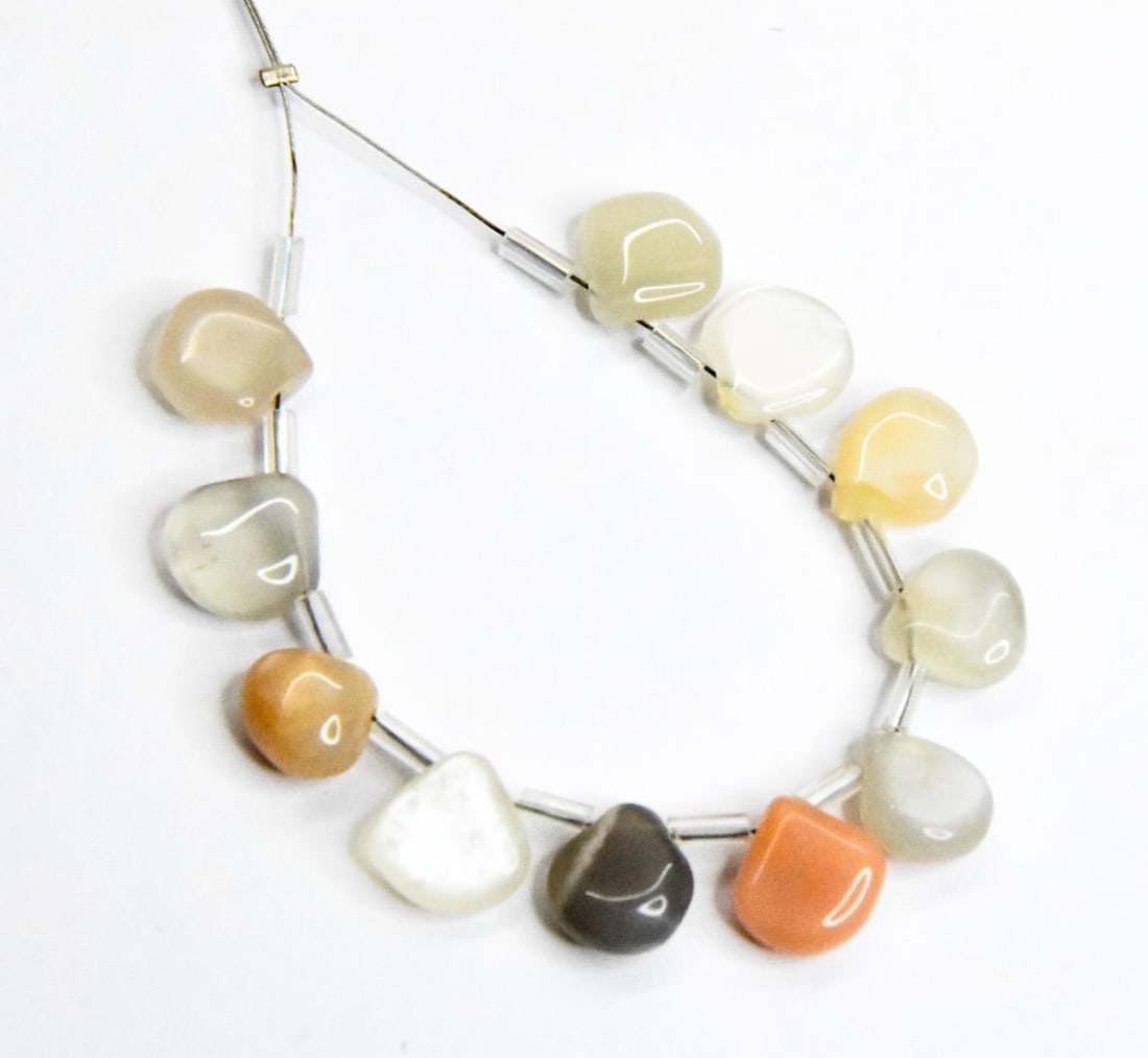 NATURAL MULTI MOONSTONE BEADS HEART 9 - 10 MM 11 PCS: These are natural, earth mined and hand crafted with precision. Stone: Moonstone, Stone Shape: Heart, Stone Size: 9 - 10 mm, Width: 4 - 5.5 mm, Weight: approx. 33 carats. The photographs are enlarged
