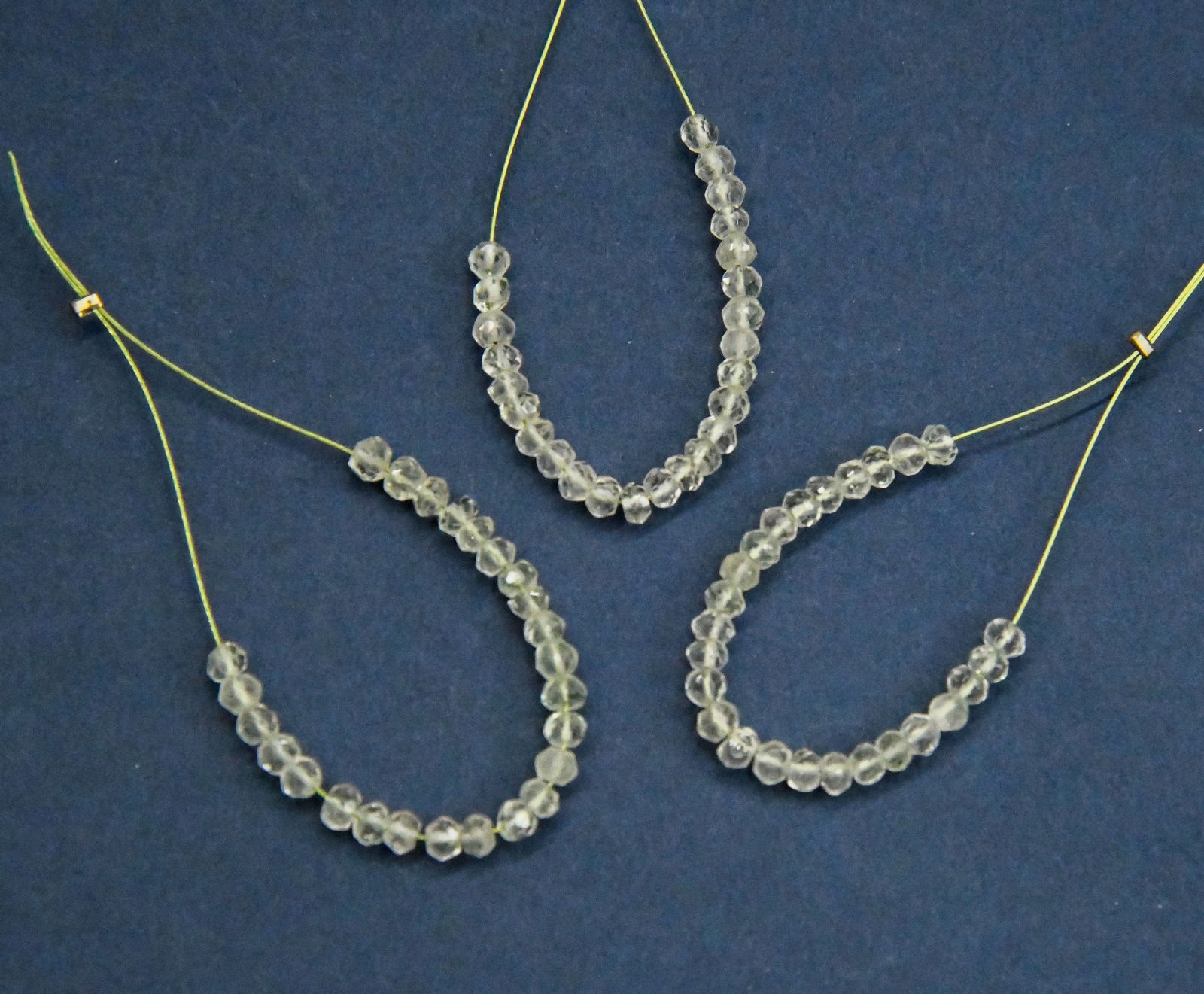 NATURAL GREEN AMETHYST BEADS FACETED RONDELLE 3 - 3.5 MM, 25 PCS (4 TASSELS): These are natural, earth mined and hand crafted with precision. Stone: Green Amethyst, Stone Shape: Faceted Rondelle, Stone Size: 3 - 3.5 mm, Width: 2 - 2.5 mm, Weight: approx. 4.85 carats. The photog