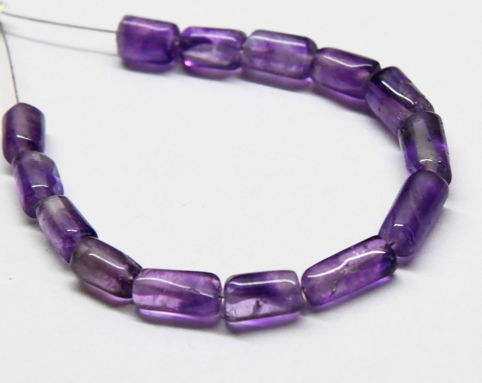 NATURAL AMETHYST BEADS TUBE 4X6 - 4X9 MM, 14 PCS: These are natural, earth mined and hand crafted with precision. Stone: Amethyst, Stone Shape: Tube, Stone Size: 4.5x6.5 - 4.5x9.5 mm, Weight: approx. 21 carats. The photographs are generally enlarged